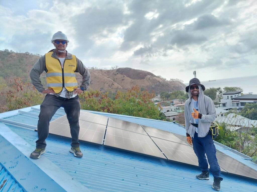 GoKoval installers on a completed rooftop solar system in Dili