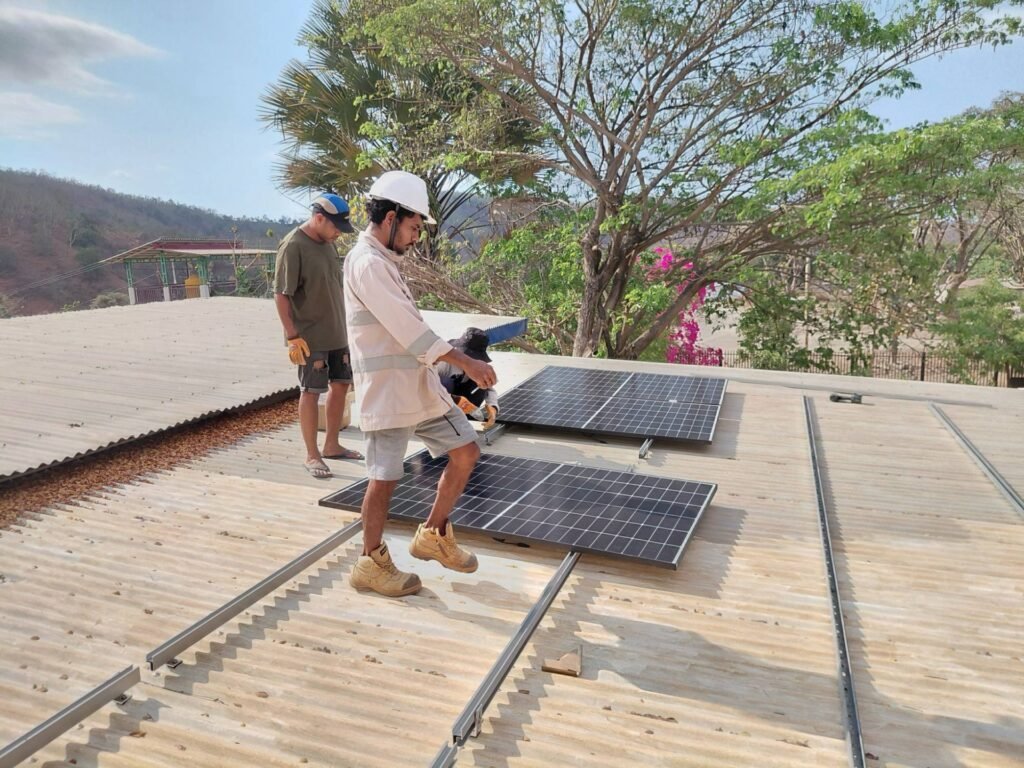 GoKoval technicians installing solar panels on a roof