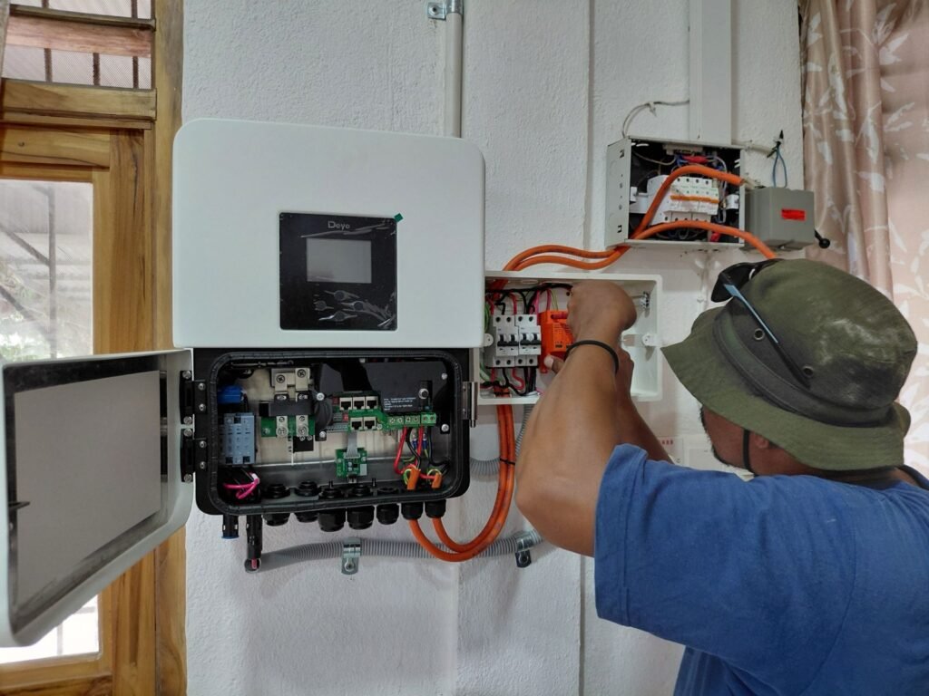 GoKoval technician wiring a hybrid inverter and protection board